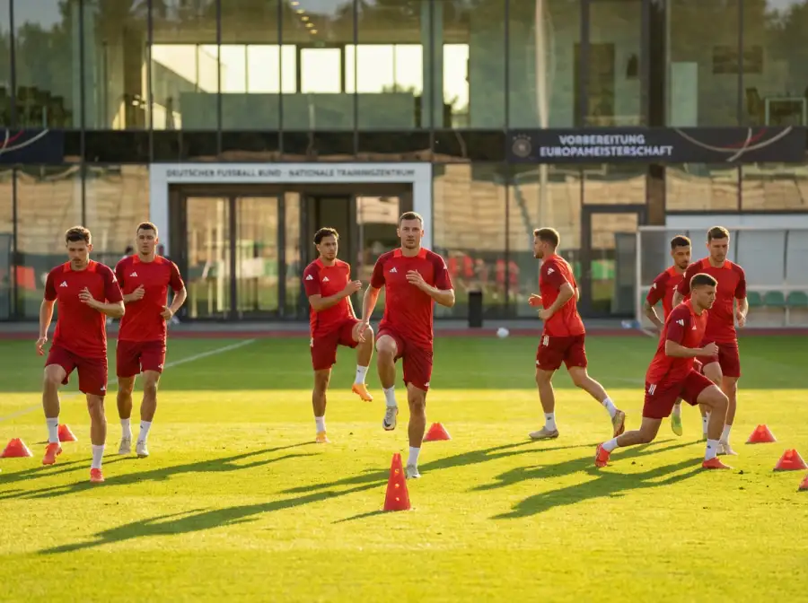 Schweizer Nationalmannschaft in roten Trikots beim Aufwärmen auf dem Trainingsplatz